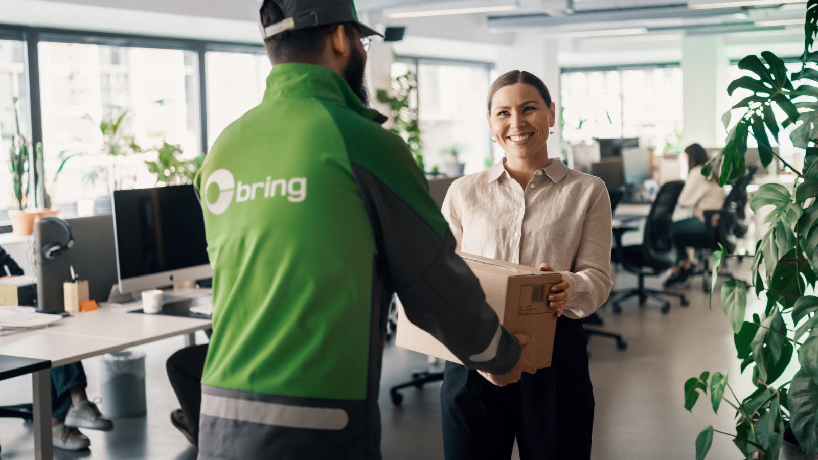 Bring-bud som leverer pakke på et kontor