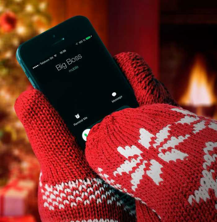 Someone using a mobile phone while wearing red Offline Gloves with 100% Anti-Touch technology