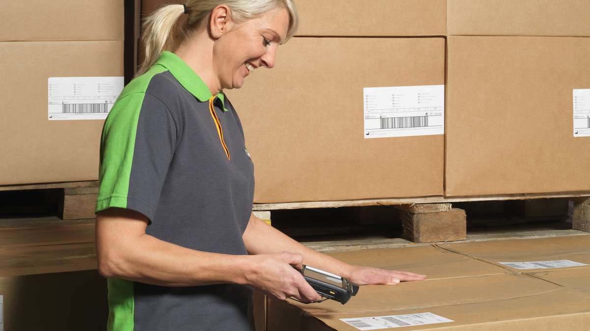 En Bring-ansatt som scanner en pakkeetikett